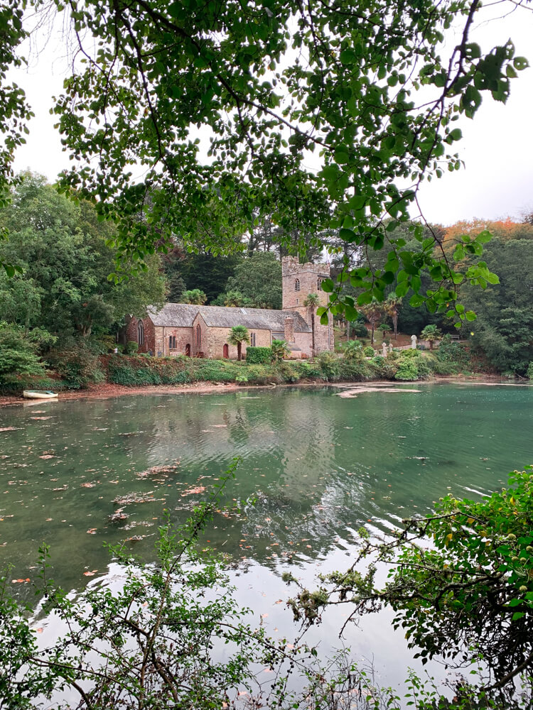 View across water to St Just's Church on the Roseland Peninsula in Cornwall