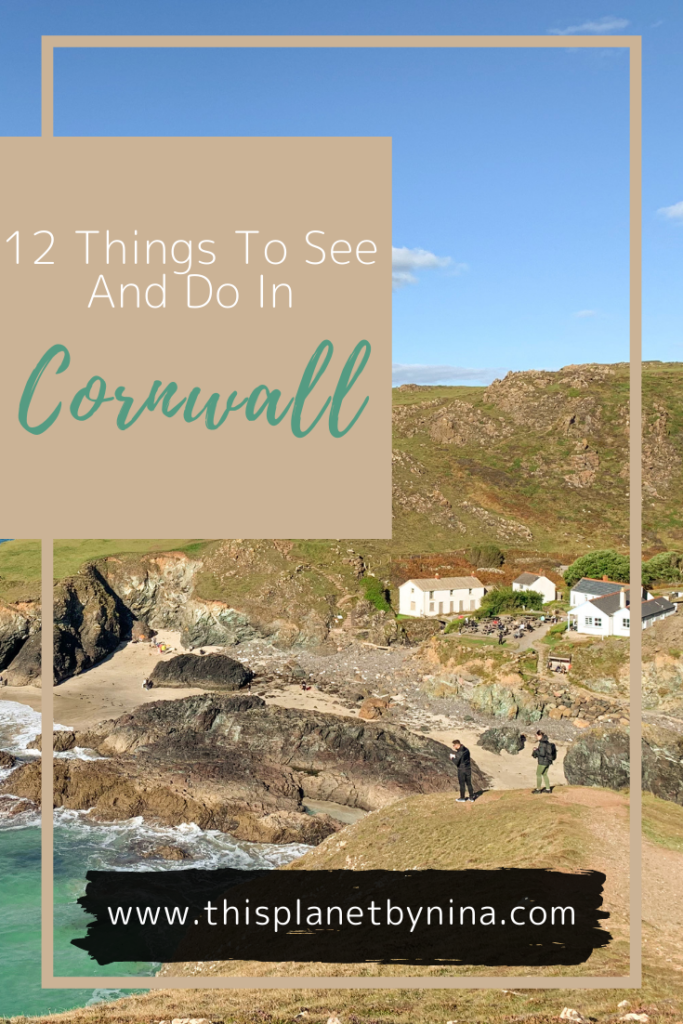 A view looking down at the beach and white buildings of Kynance Cove, Cornwall. The heading '12 Things To See And Do In Cornwall' is at the top.