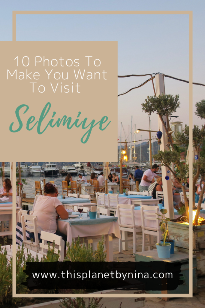 Diners sit at an al fresco restaurant in Selimiye, Turkey, surrounded by mountains, yachts and pretty lights. The heading '10 Photos To Make You Want To Visit Selimiye' is at the top.