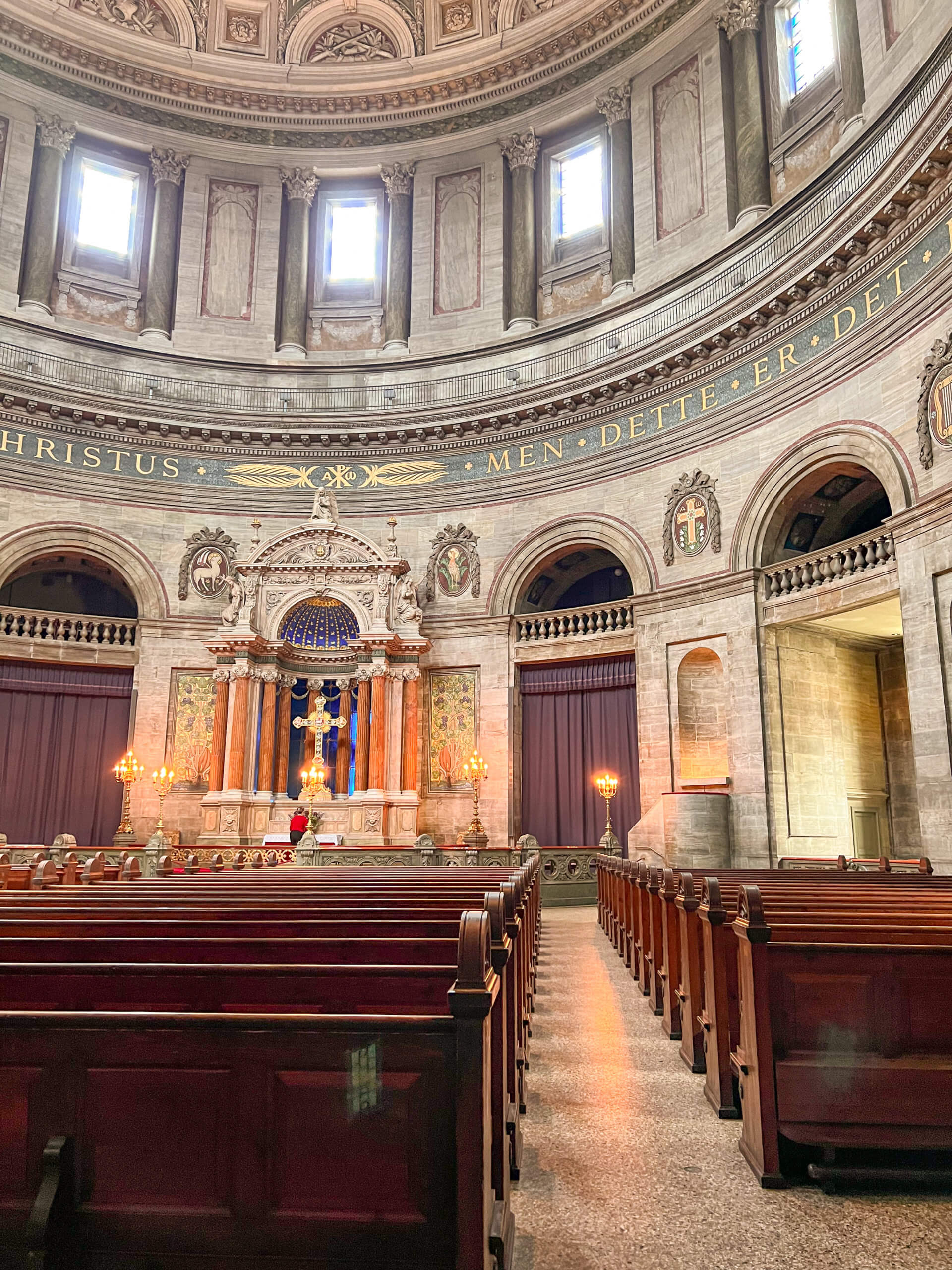 View of the pews and part of the curved ornate walls inside Frederik's Church. One of my top 10 places to visit in Copenhagen.