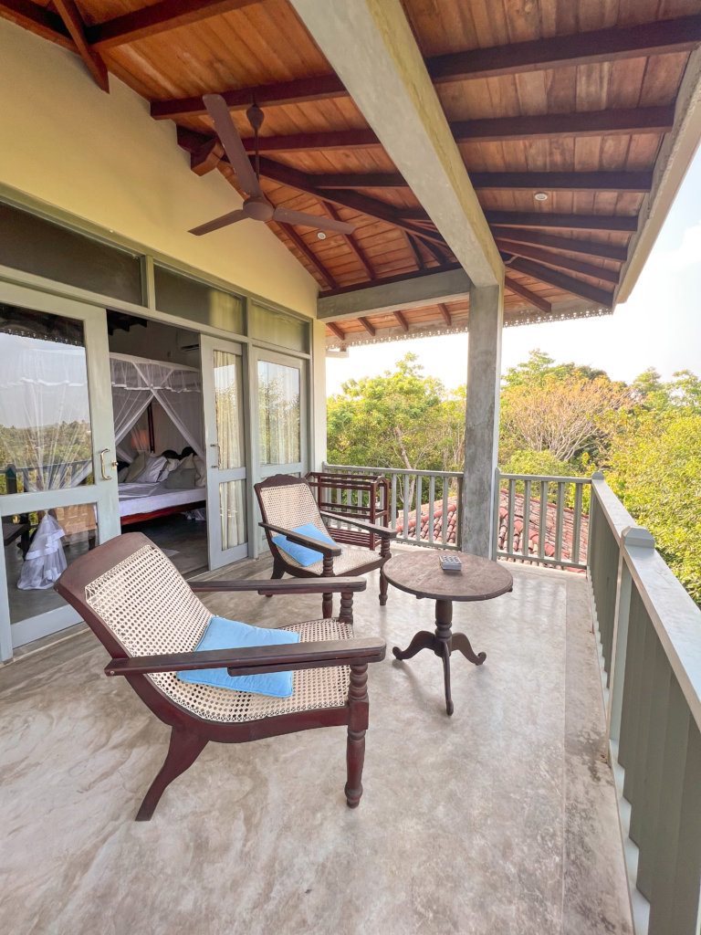 Two chairs sit facing out to the view on the large balcony at the Horizon Hilltop Villa, one of the best introvert friendly places to stay in Sri Lanka.