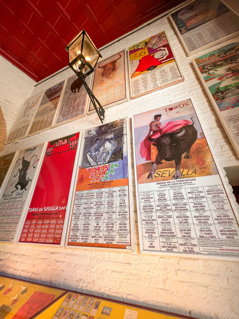 Matador posters on a wall inside the Plaza de Toros - 10 things to do in Seville