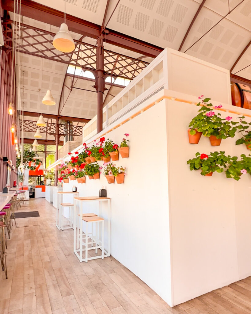 Flower pots line the walls inside the Mercado Lonja del Barranco - 10 things to do in Seville